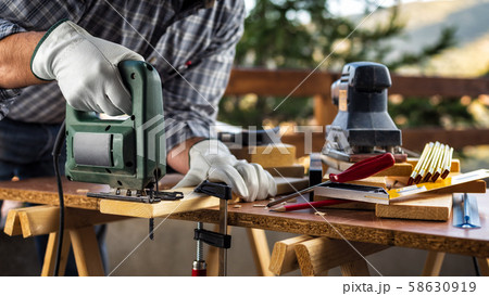 Craftsman at work on wooden boards. Carpentry. 58630919
