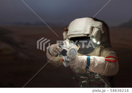 Spaceman with a camera in a space suit  58636218