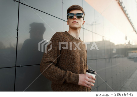 Young handsome man with coffee in sunglasses 58636445