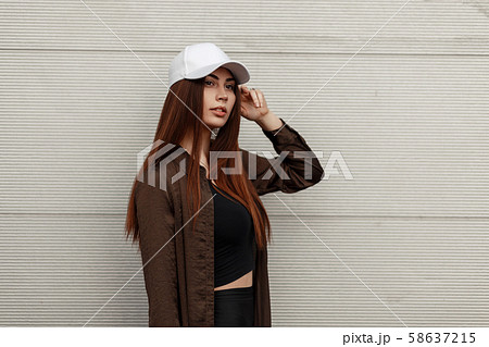 Pretty young girl with a white stylish cap Pretty young girl with a white stylish cap 58637215