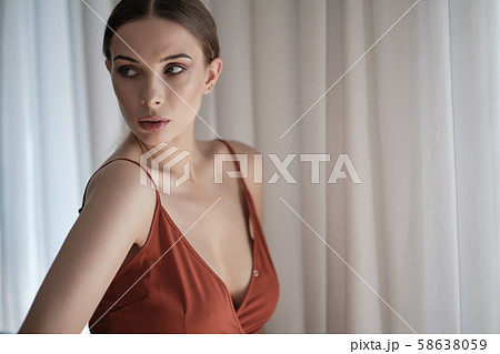 Sensual beautiful blonde woman posing in red Sensual beautiful blonde woman posing in red 58638059