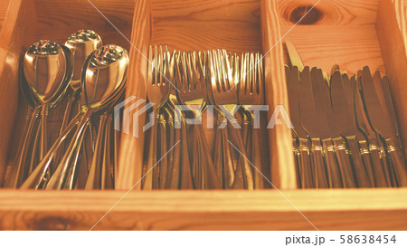 Spoons, forks, knives in the tray. Wooden drawer with modern cutlery. Kitchen or restaurant concept 58638454