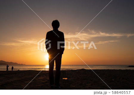 サンセットビーチに立つ男性の後ろ姿 58640557