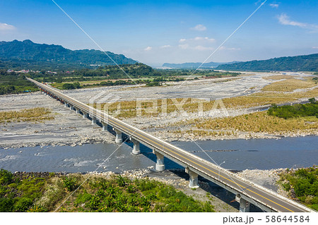 bridge over river with golden miscanthus 58644584