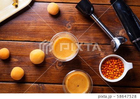 blender  laying at wooden table with fresh fruit 58647528