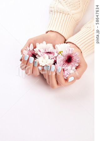 Many flowers in women's hands. 58647634