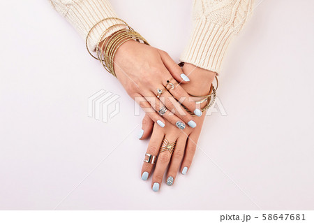 Gold and silver jewelry on women's hands. Gold and silver jewelry on women's hands. 58647681