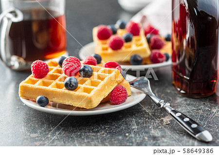 Waffles with blueberries and raspberries. Waffles with blueberries and raspberries. 58649386