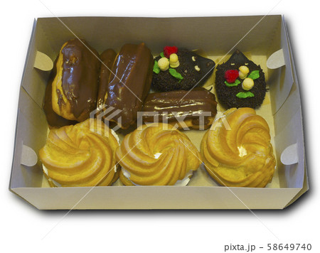 Box with cakes in order to quickly celebrate the holiday. Pack of confectionery with whipped cream and chocolate. Isolated object. Box with cakes in order to quickly celebrate the holiday. Pack of confectionery with whipped cream and chocolate. Isolated object. 58649740