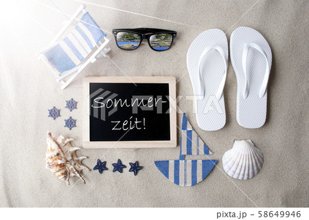 Sunny Blackboard On Sand, Sommerzeit Means Sunny Blackboard On Sand, Sommerzeit Means 58649946