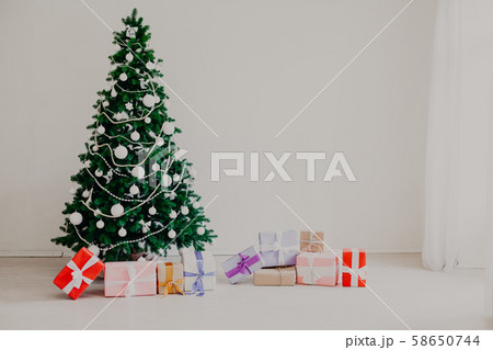 Christmas tree in the white room a lot of new year gifts 58650744