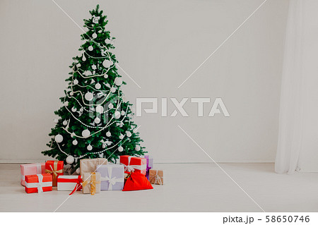 Christmas tree in the white room a lot of new year gifts Christmas tree in the white room a lot of new year gifts 58650746