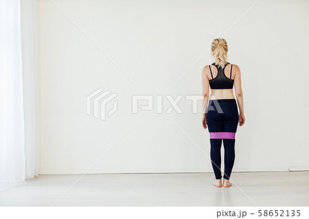 Female athlete squats with fitness gum sports 58652135