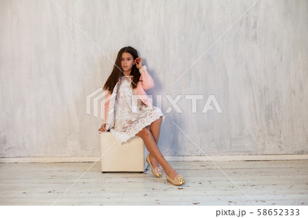 Portrait of a beautiful brunette girl in pink clothes Portrait of a beautiful brunette girl in pink clothes 58652333