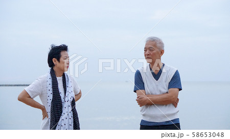 Asian elderly couple fight upset at ocean sea Asian elderly couple fight upset at ocean sea 58653048