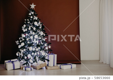 Christmas tree with lights Garland gifts at Brown white background 58653660