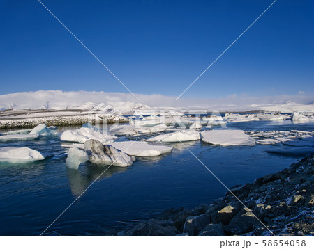 Ice chunks from the glacier drift in calm water 58654058