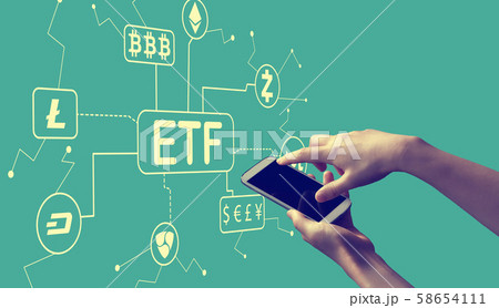 Cryptocurrency ETF theme with person holding smartphone 58654111