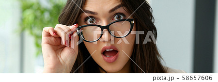 Young beautiful business woman holding glasses 58657606