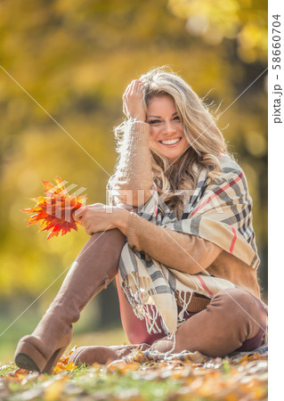 Attractive young woman with sensual smile sitting 58660704