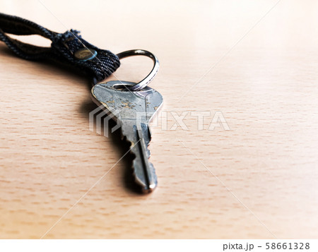 Silver key isolated on wood floor selective focus 58661328