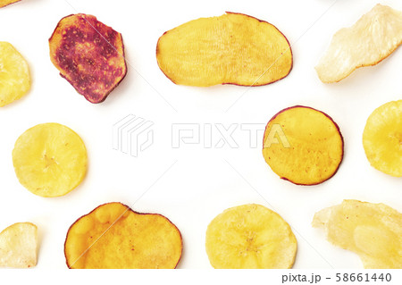Dried fruit and vegetable chips, healthy vegan snack, top shot on a white background, forming a 58661440