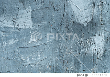 The texture of gypsum or alibaster cracked plaster on the wall is a thick layer. Gradient blue putty 58664326