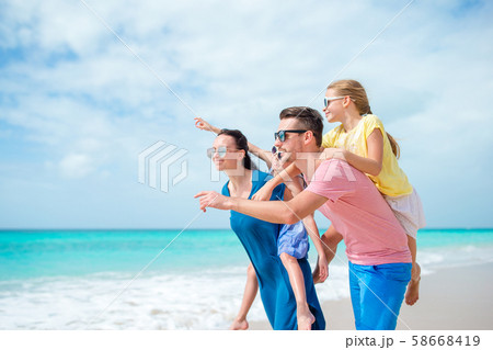 Happy family on the beach during summer vacation Happy family on the beach during summer vacation 58668419