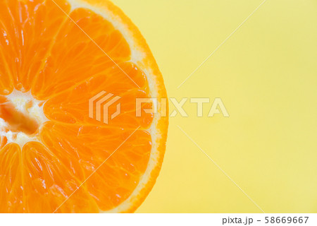 orange slice on yellow background / close up of 58669667