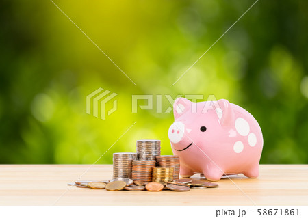 Pink piggy bank with coin stack steps with 58671861