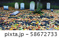 Autumn ancient graveyard with orange leaves and 58672733