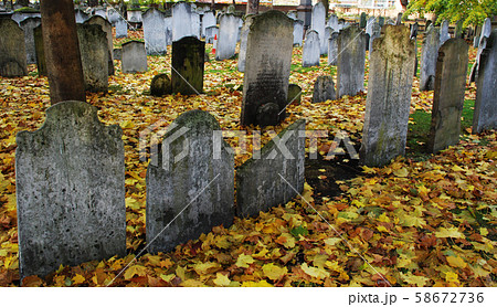 Autumn ancient graveyard with orange leaves and 58672736