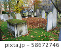 Autumn ancient graveyard with orange leaves and 58672746