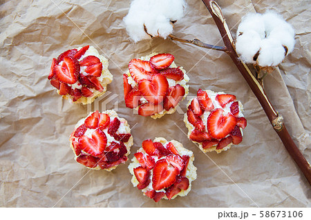 Very tasty muffins with fresh strawberries lie on 58673106