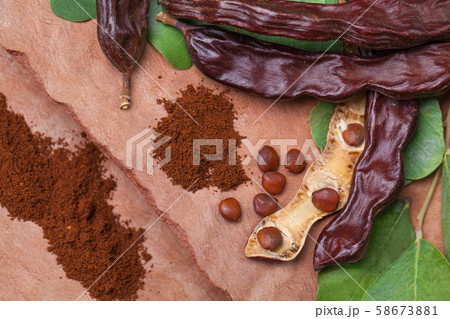 Carob. Organic carob pods with seeds and leaves Carob. Organic carob pods with seeds and leaves 58673881
