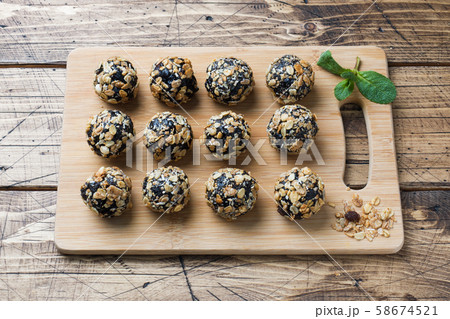 Healthy energy balls made of dried fruits and nuts with oatmeal and muesli . Raw vegan candy. Healthy energy balls made of dried fruits and nuts with oatmeal and muesli . Raw vegan candy. 58674521
