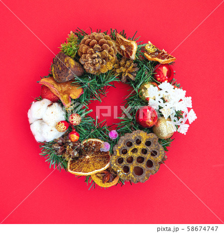 Decorative Christmas wreath on red background 58674747