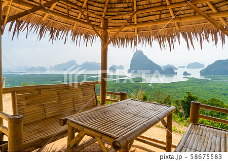 Wooden table and chairs in thai pavilion at Samet 58675583