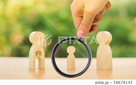 A magnifying glass looks at a child's figure stands between father and mother. The child chooses which parent to live with after their divorce. Guardianship over child. interest of child A magnifying glass looks at a child's figure stands between father and mother. The child chooses which parent to live with after their divorce. Guardianship over child. interest of child 58678142