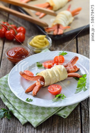 Baked Vienna sausages wrapped with puff pastry fresh from the oven,often served as a children’s meal 58679475