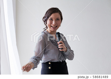 portrait of a beautiful Asian woman with a microphone talking portrait of a beautiful Asian woman with a microphone talking 58681489