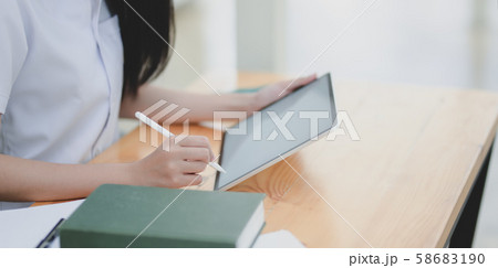 Cropped shot of young female doctor examining the 58683190