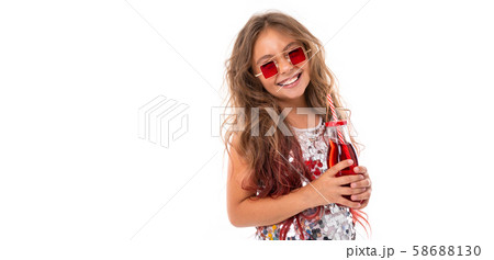 Smiling little girl with coctail in her hands at white background Smiling little girl with coctail in her hands at white background 58688130