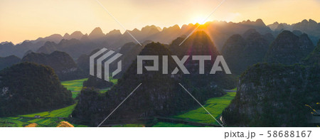 Panoramic view of Sunset with Rapeseed flower field at Wanfenglin National Geological Park (Forest of Ten Thousands Peaks), China Panoramic view of Sunset with Rapeseed flower field at Wanfenglin National Geological Park (Forest of Ten Thousands Peaks), China 58688167