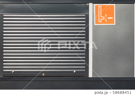 Metal roller shutter door with orange sign Metal roller shutter door with orange sign 58688451