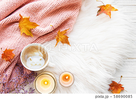 Cup of coffee and autumn leaves on a fur 58690085
