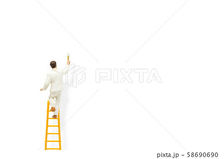 Painter standing on wooden ladder and painting white wall with paint tools. Painter standing on wooden ladder and painting white wall with paint tools. 58690690