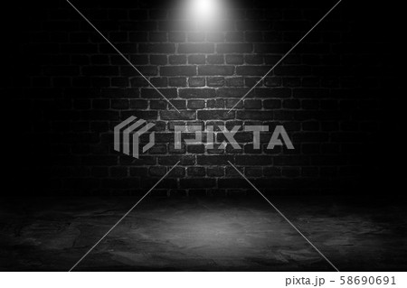 Spot lighting with black brick wall in background. 58690691