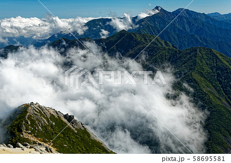 甲斐駒ヶ岳山頂から見る摩利支天と雲湧く北岳 58695581