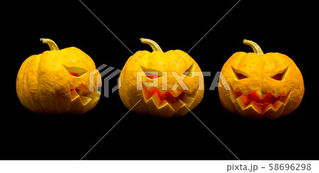 Jack o lantern pumpkin faces with lights on black background for Halloween season Jack o lantern pumpkin faces with lights on black background for Halloween season 58696298
